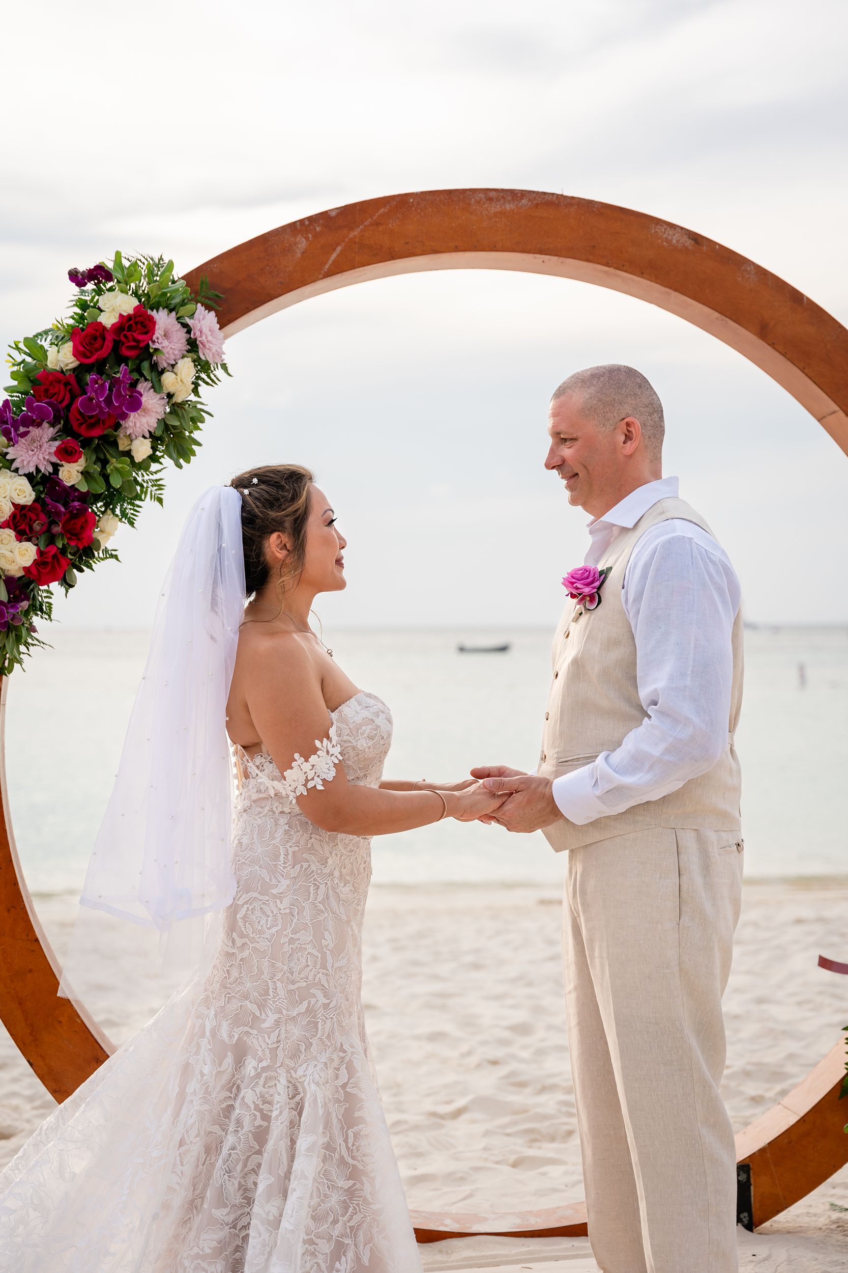 Couple getting married in front of circle arch in Aruba