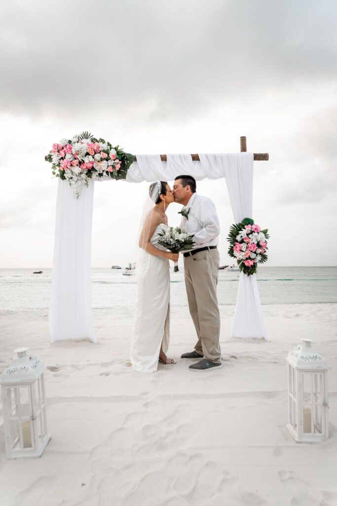 Kiss at alter during elopement at Hyatt Regency Aruba