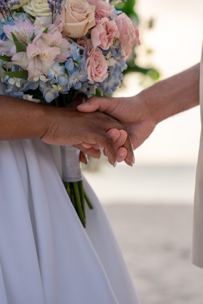 Couple holding hands at wedding ceremony