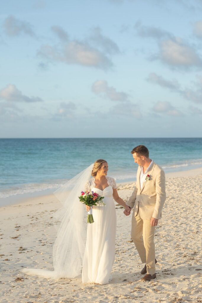 Bride and groom walking Aruba beach after elopement