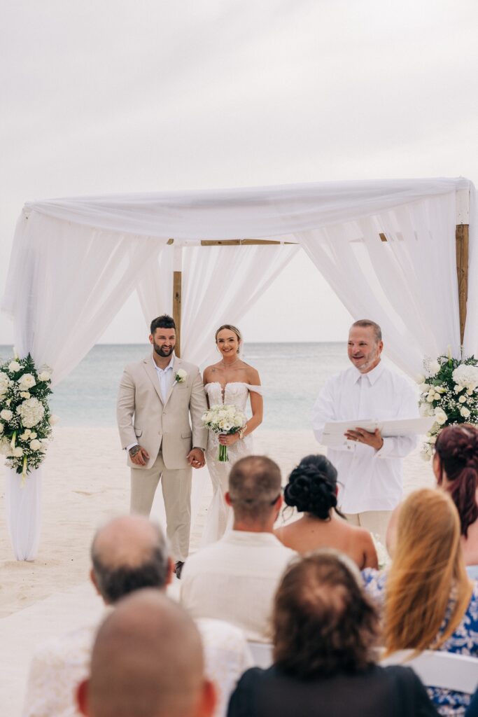 Bride and groom with Aruba officiant during ceremony
