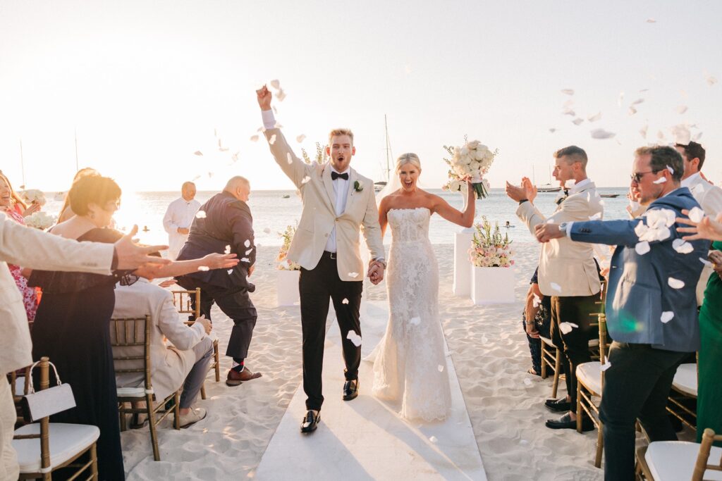 Bride and groom walking Aruba ceremony aisle on beach