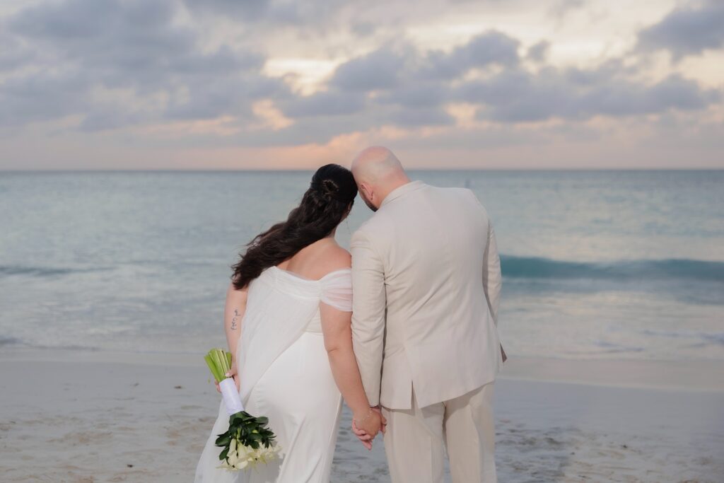 Bride and groom looking at Aruba water