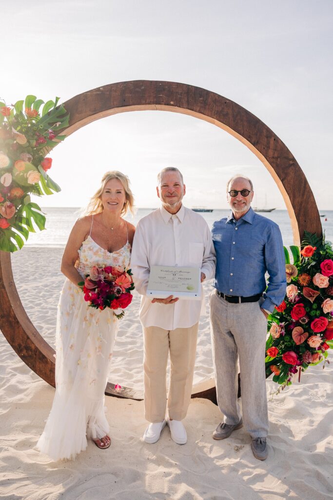Aruba officiant smiling with bride and groom at wedding