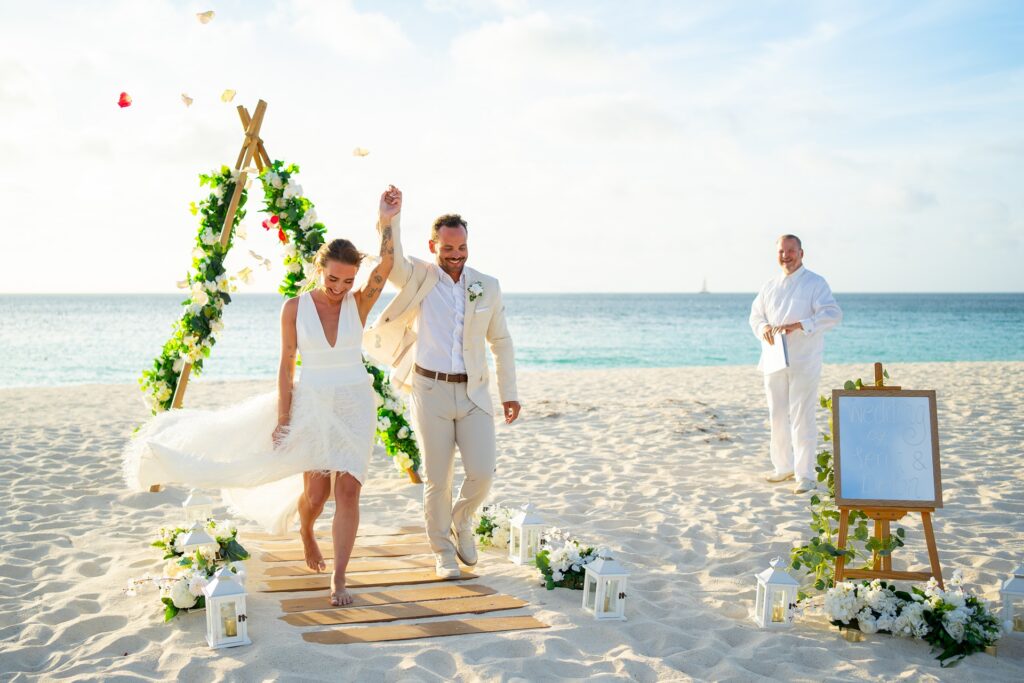 Couple walking ceremony aisle after Aruba elopement ceremony