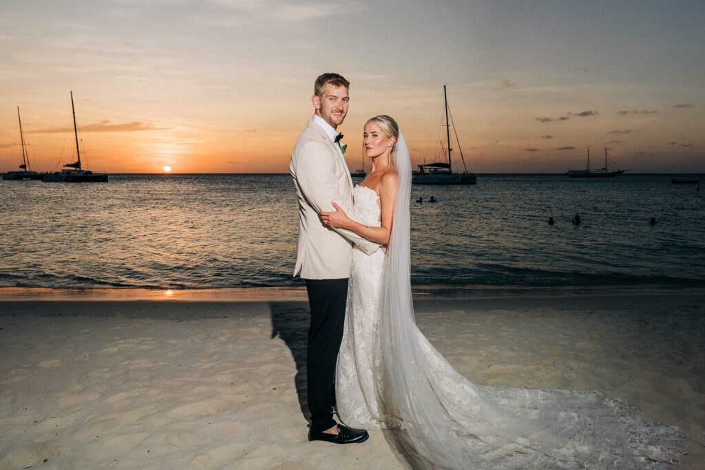 Bride and groom posing at Aruba sunset wedding