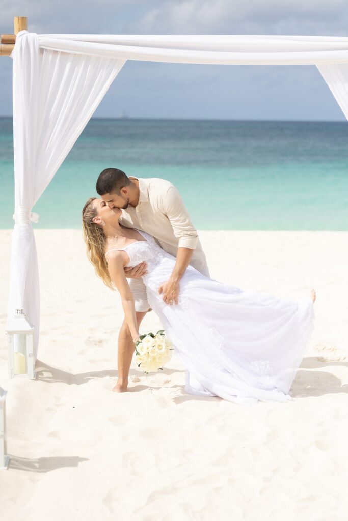 Groom dipping bride at Aruba elopement ceremony