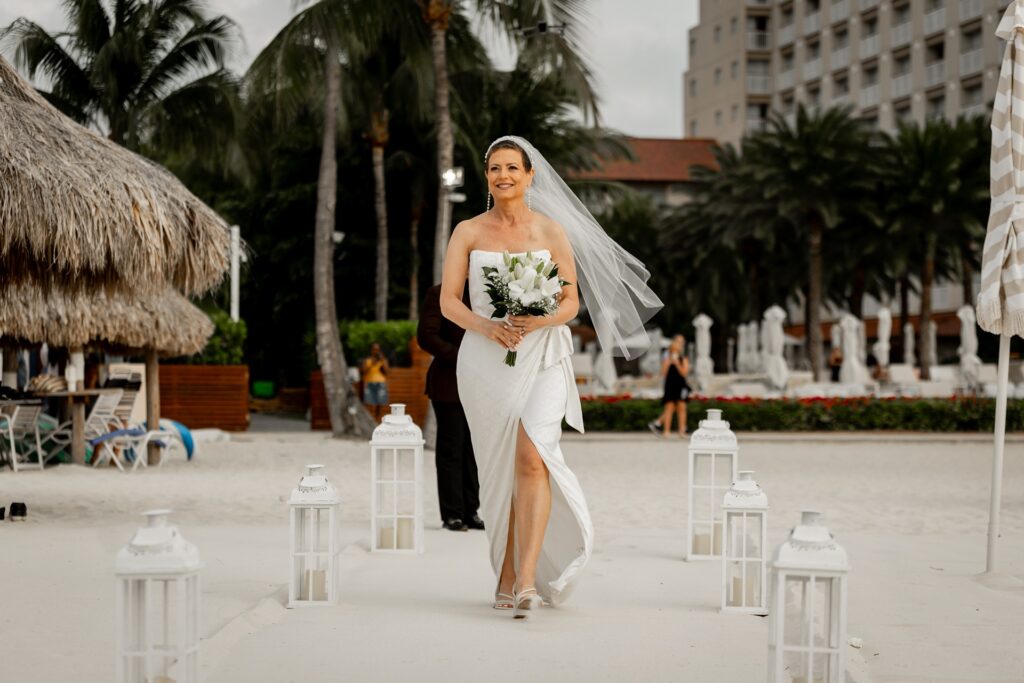 Bride walking ceremony aisle at Hyatt Aruba elopement