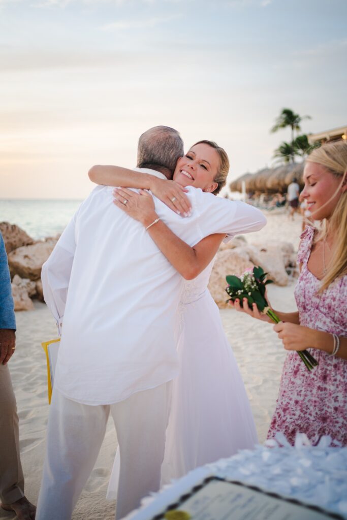 Bride hugging Aruba officiant
