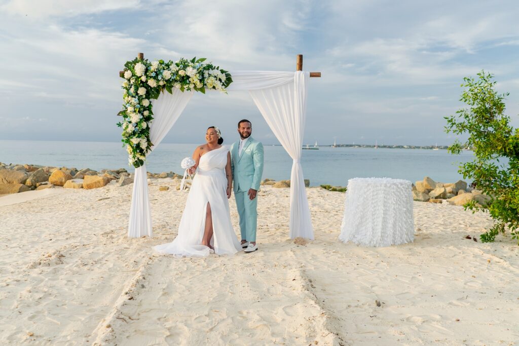 Bride and groom under arch for Aruba elopement